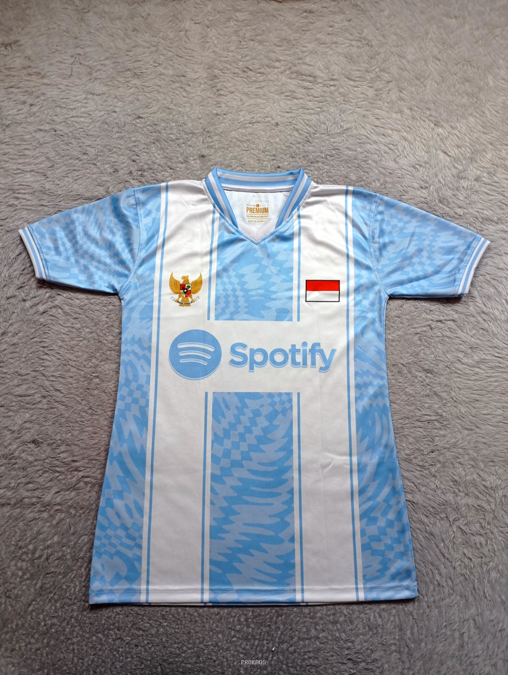 Jersey Bola Biru-Putih dengan Logo Garuda dan Spotify - Jersey Custom PROKAOS